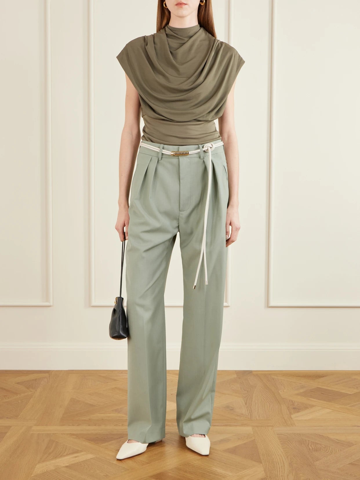 Image of a model wearing Pants. Product name - Aiden Pleated Grain De Poudre Straight-leg Pants in Sage green colour by brand - KALLMEYER