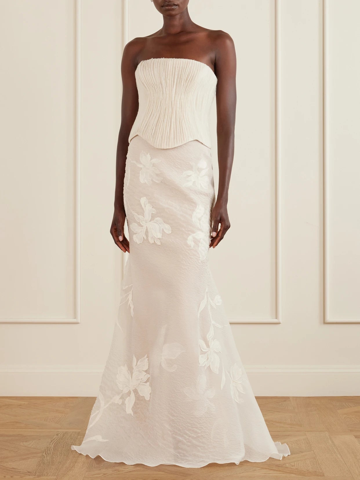 Image of a model wearing Skirts. Product name - Dean Floral-embroidered Silk-blend Organza Maxi Skirt in Off-white colour by brand - Danielle Frankel