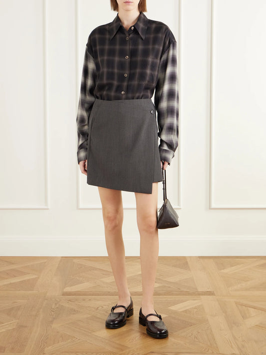 Image of a model wearing Skirts. Product name - Titled Wool-twill Mini Wrap Skirt in Taupe colour by brand - MFPEN