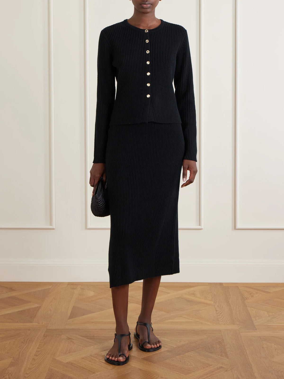 Image of a model wearing Outerwear. Product name - Wool And Cashmere-blend Ribbed Cardigan in Black colour by brand - Allude