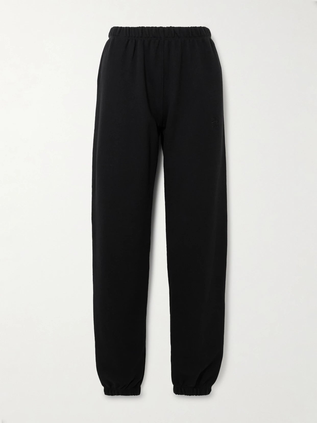 Image of a model wearing Pants. Product name - Cotton And Modal-blend Jersey Tapered Track Pants in Black colour by brand - ÉTERNE