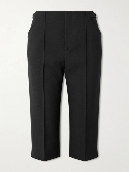 Image of a model wearing Pants. Product name - Buckle-embellished Wool-crepe Straight-leg Capri Pants in Black colour by brand - Chloé