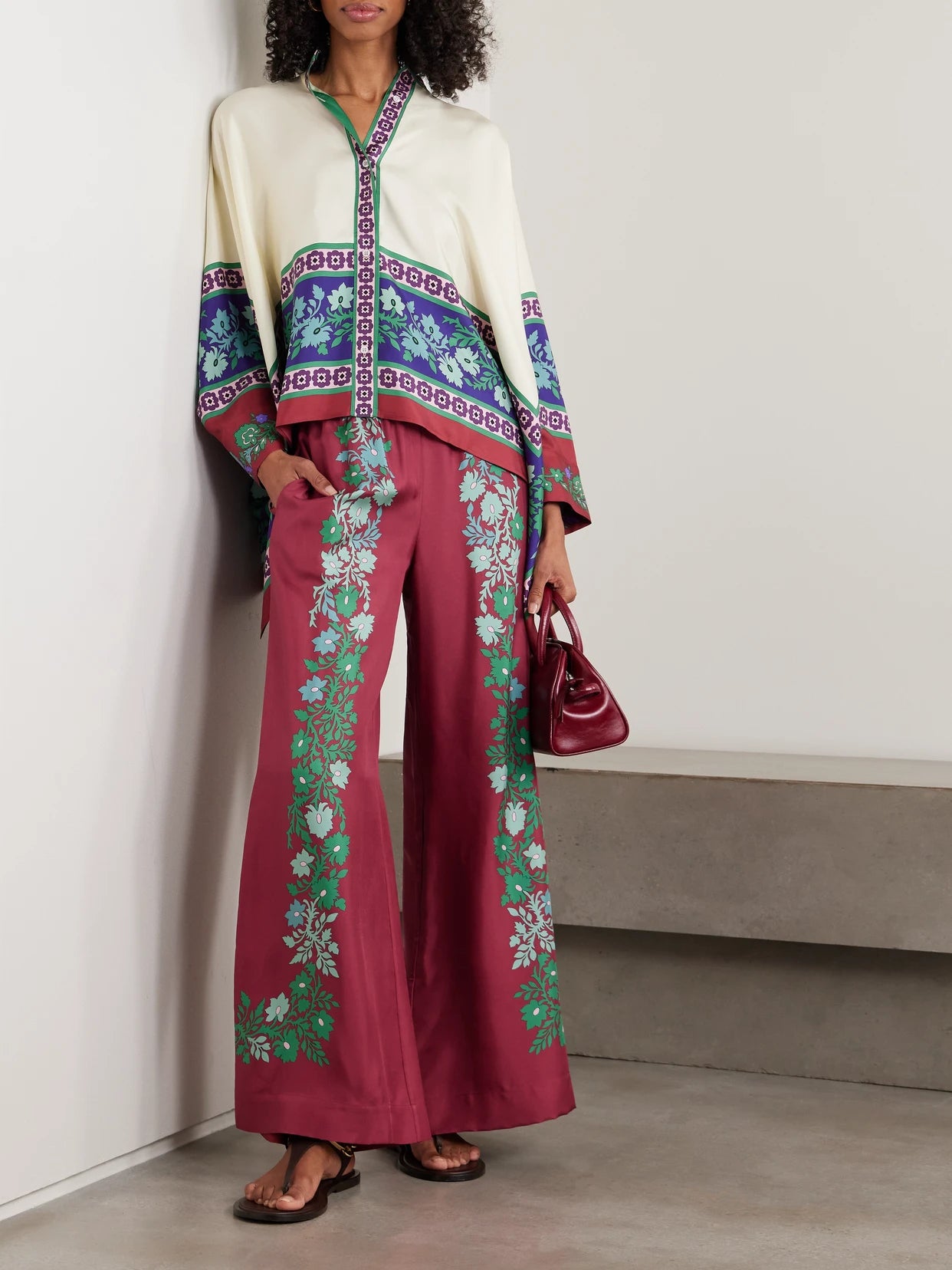 Image of a model wearing Pants. Product name - Palazzo Printed Silk Wide-leg Pants in Burgundy colour by brand - La DoubleJ