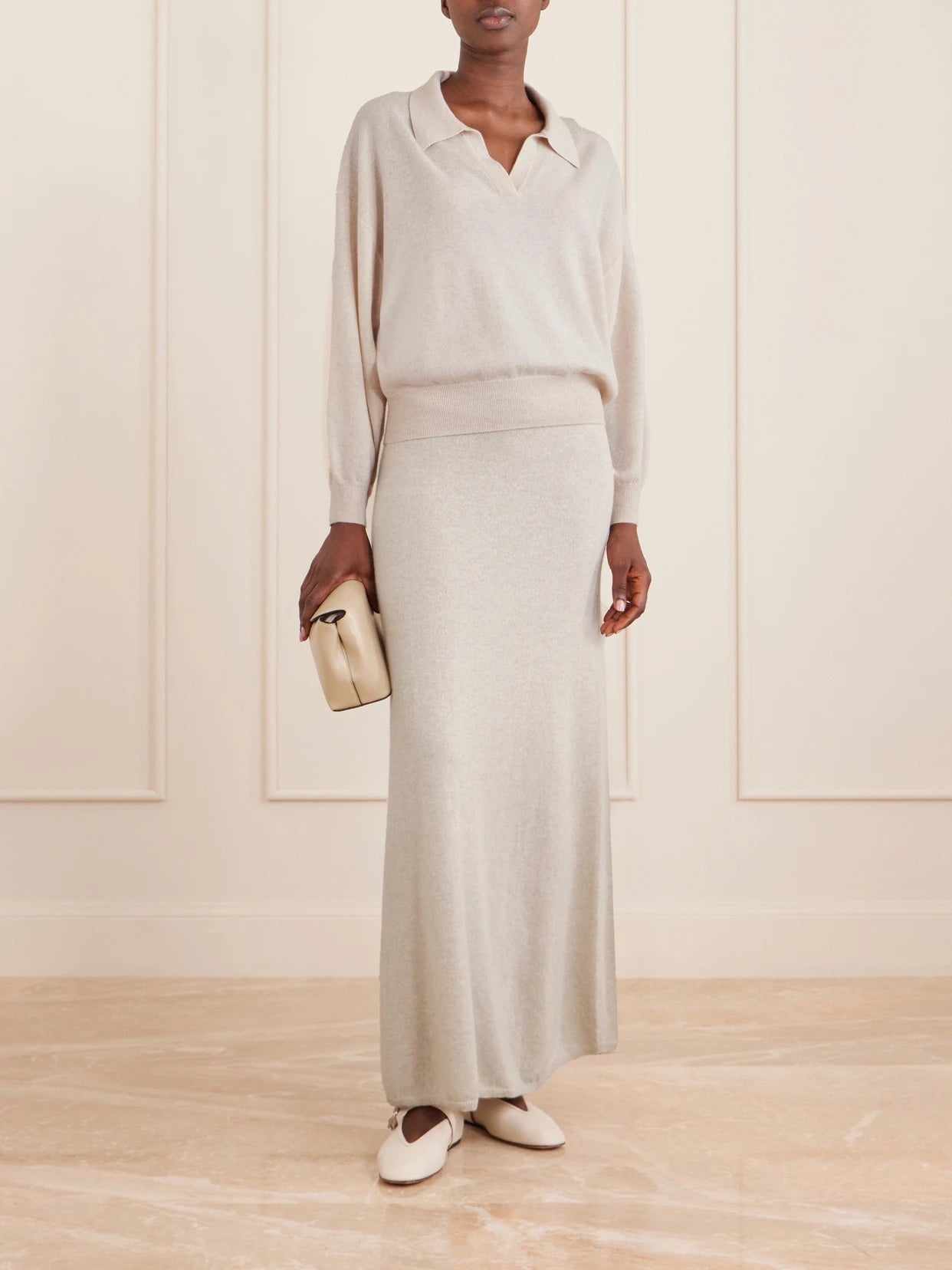 Image of a model wearing Outerwear. Product name - Katriel Cashmere Polo Sweater in Cream colour by brand - LISA YANG