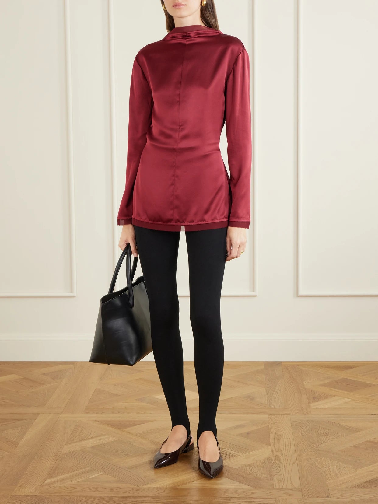 Image of a model wearing Tops. Product name - Beau Knotted Silk Blouse in Burgundy colour by brand - TOVE