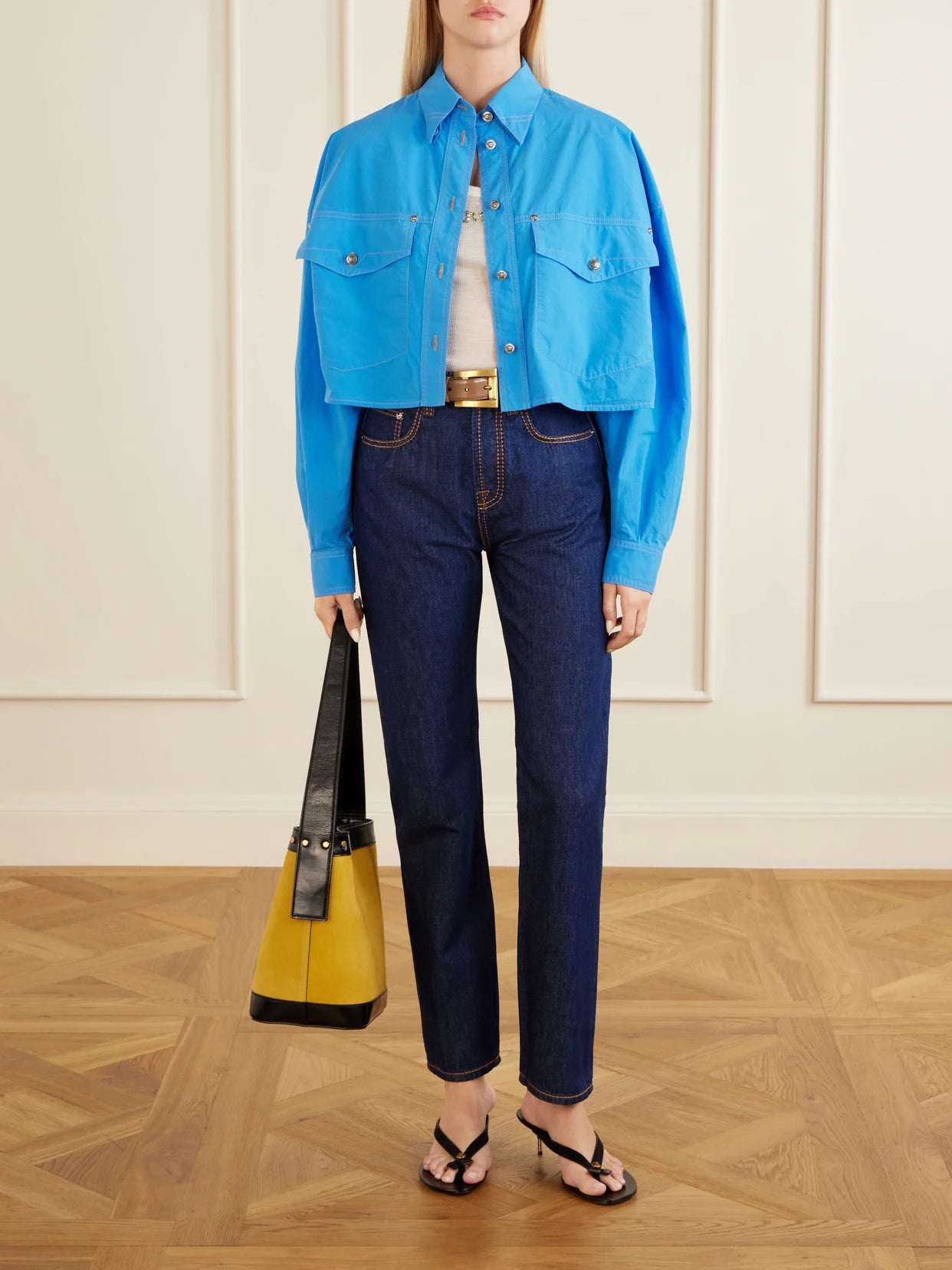 Image of a model wearing Tops. Product name - Medusa-embellished Cropped Cotton-poplin Shirt in Blue colour by brand - Versace