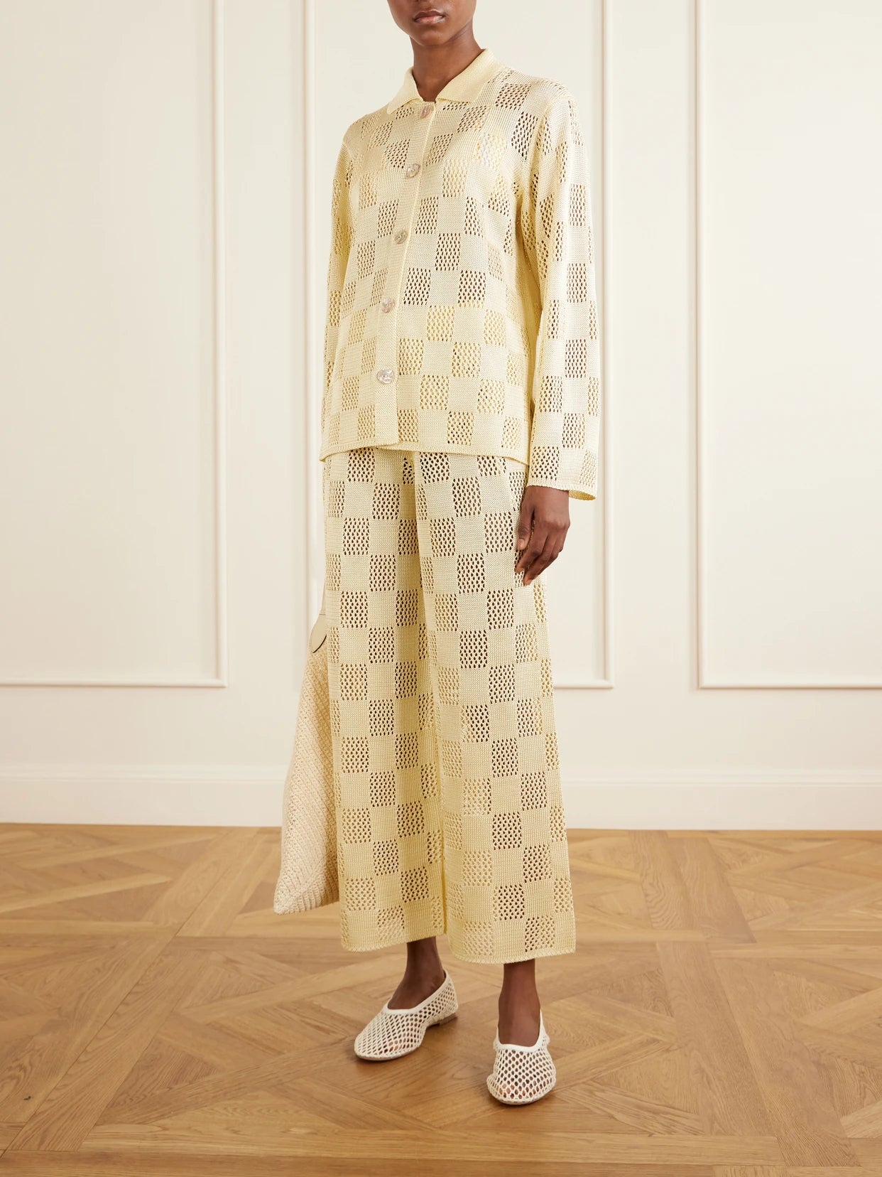 Image of a model wearing Pants. Product name - Checked Woven Wide-leg Pants in Pastel yellow colour by brand - Calle Del Mar