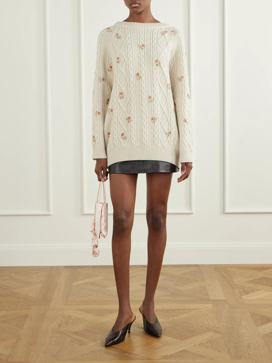 Image of a model wearing Outerwear. Product name - Floral-print Cable-knit Wool And Cashmere-blend Sweater in Cream colour by brand - Magda Butrym