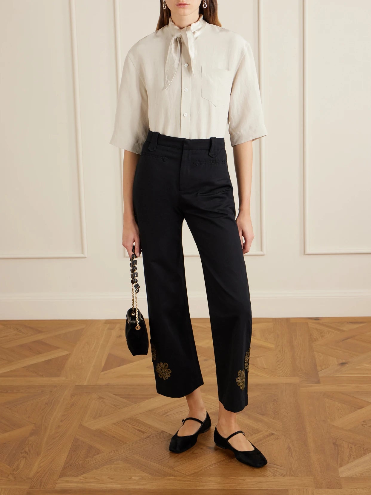 Image of a model wearing Pants. Product name - Looped Frog Wide-leg Jeans in Black colour by brand - BODE
