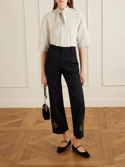 Image of a model wearing Pants. Product name - Looped Frog Wide-leg Jeans in Black colour by brand - BODE