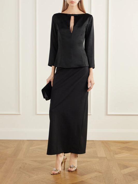 Image of a model wearing Tops. Product name - Romi Bow-detailed Darted Satin Top in Black colour by brand - BERNADETTE