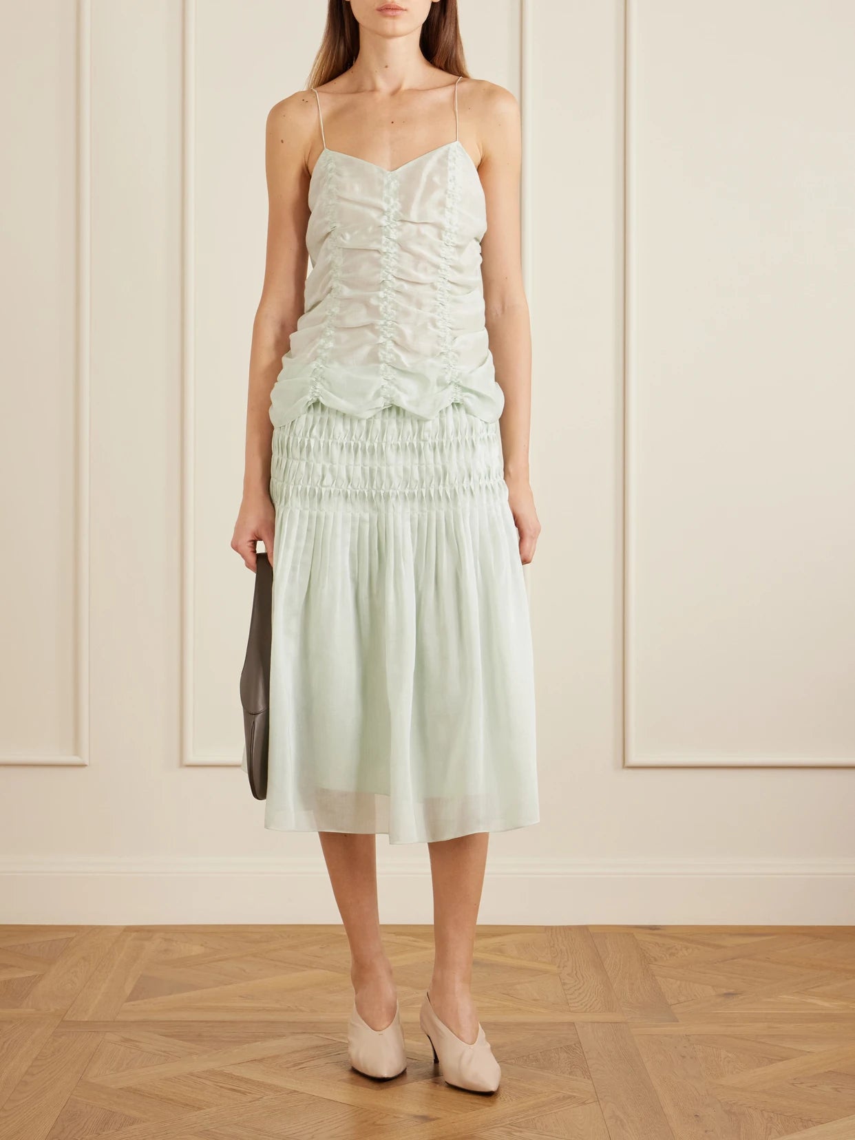 Image of a model wearing Skirts. Product name - Florence Ruched Lyocell And Silk-blend Skirt in Lime green colour by brand - KHAITE