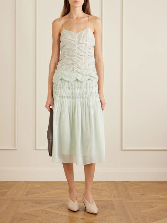 Image of a model wearing Skirts. Product name - Florence Ruched Lyocell And Silk-blend Skirt in Lime green colour by brand - KHAITE