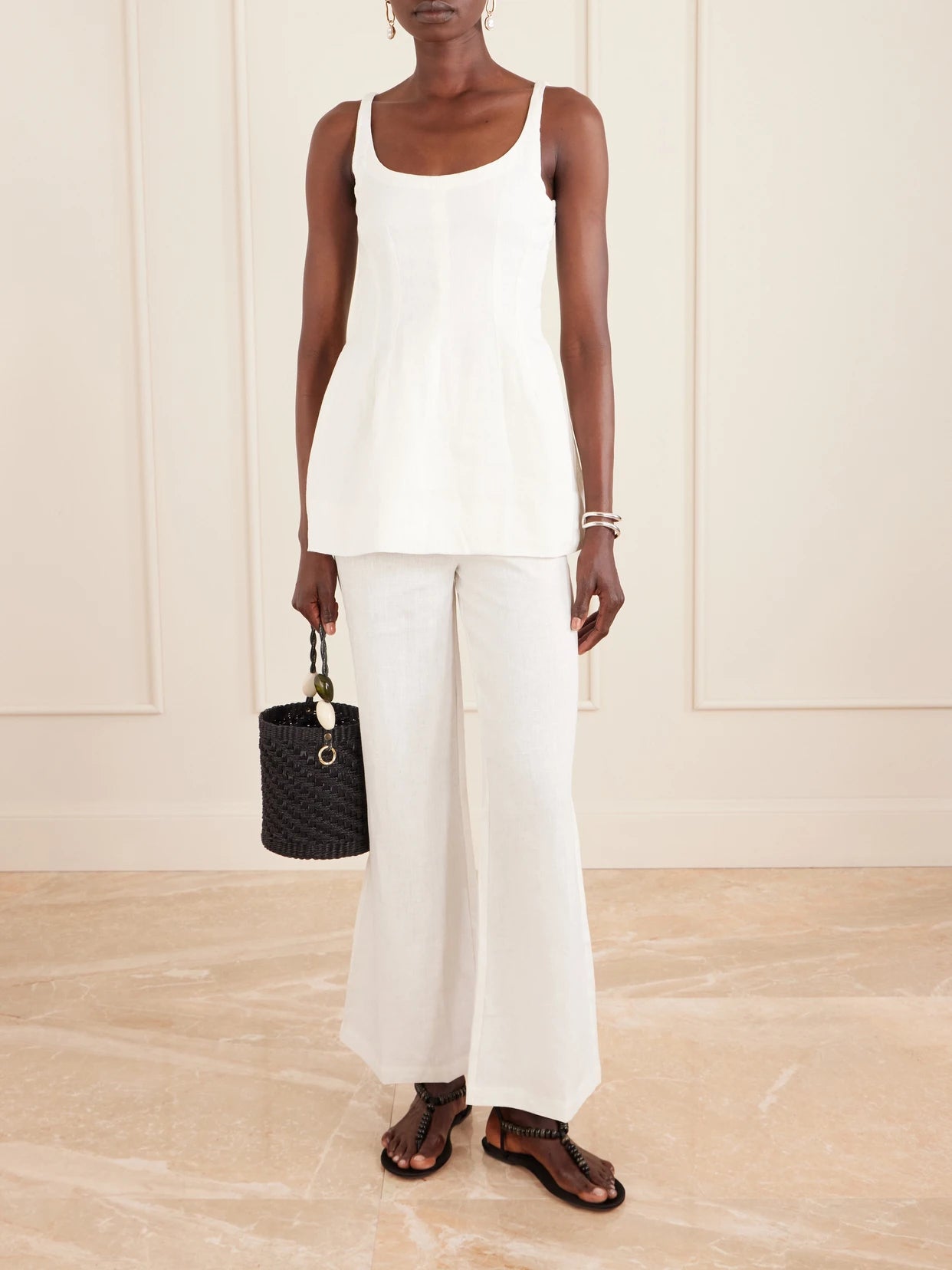 Image of a model wearing Pants. Product name - Syna Linen Straight-leg Pants in White colour by brand - Faithfull