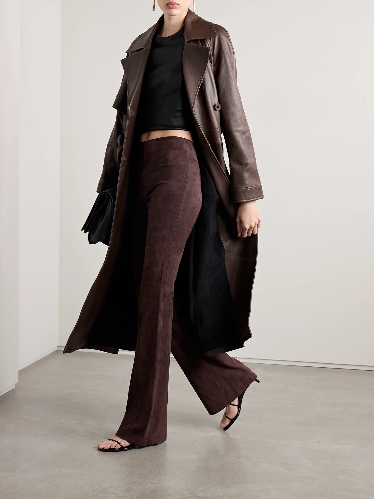 Image of a model wearing Pants. Product name - Gégé Suede Flared Pants in Dark brown colour by brand - STOULS