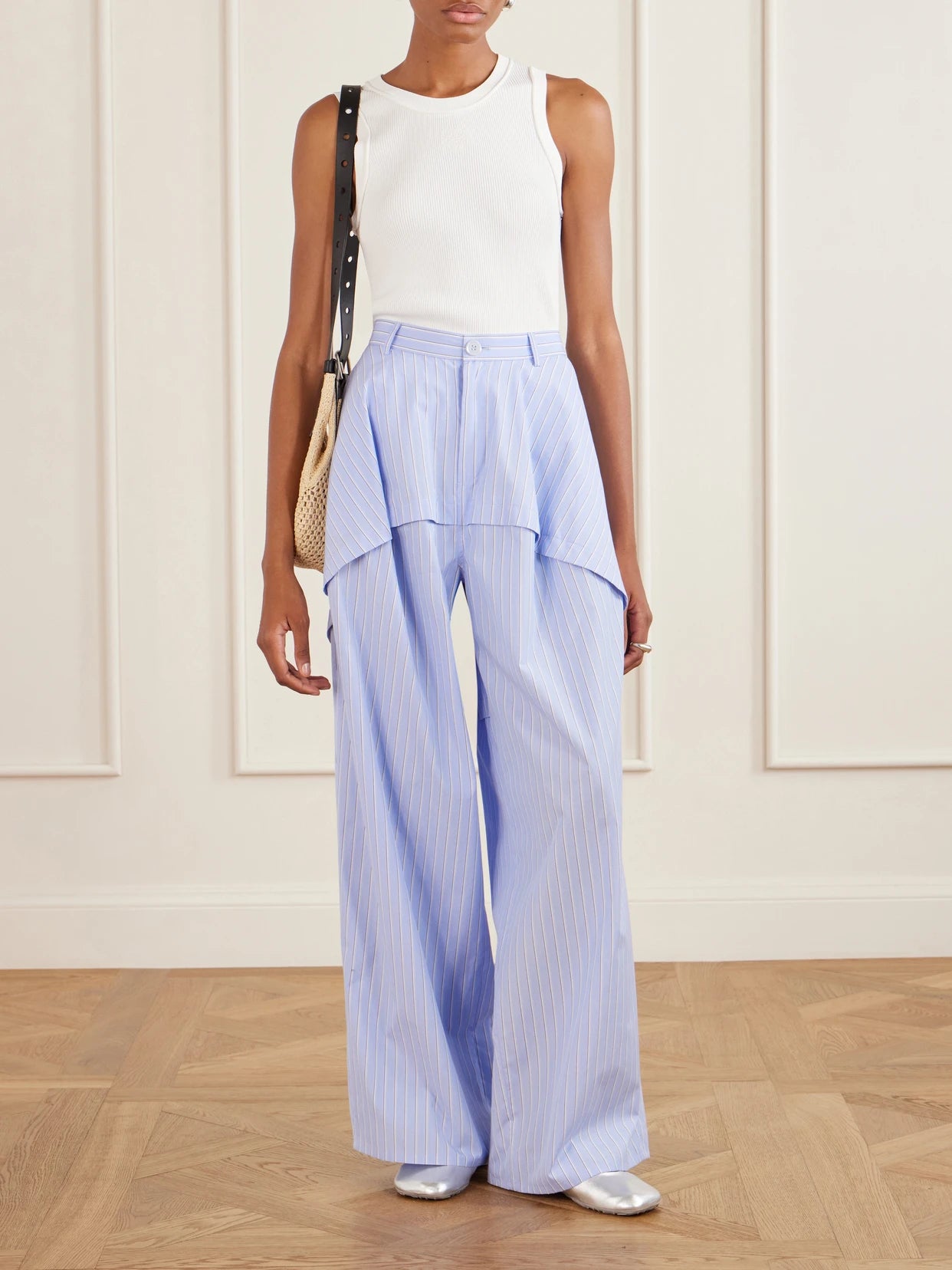 Image of a model wearing Pants. Product name - + Paula's Ibiza Striped Paneled Cotton Poplin Wide-leg Pants in Blue colour by brand - LOEWE