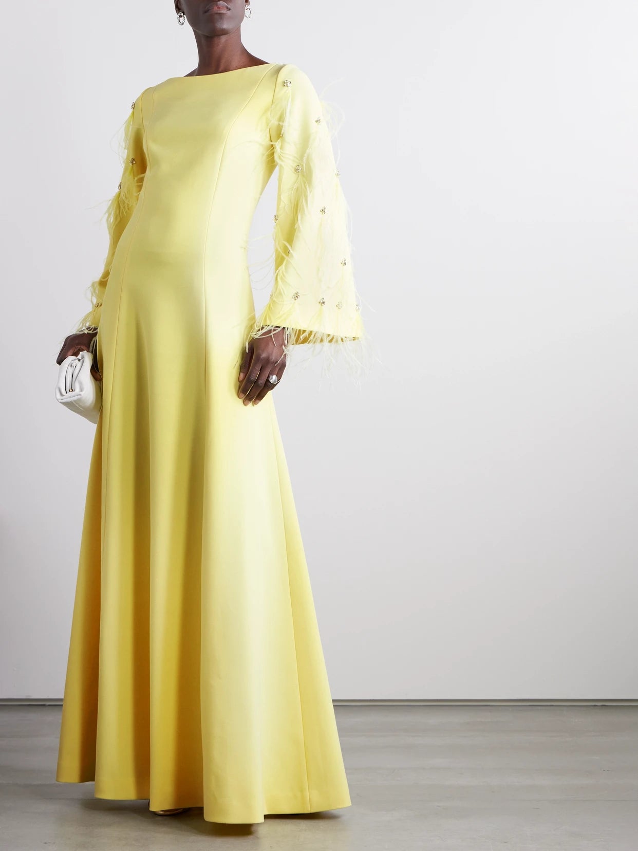 Image of Dresses. Product name - Embellished Feathered Recycled Stretch-crepe Gown in Pastel yellow colour by brand - HUISHAN ZHANG