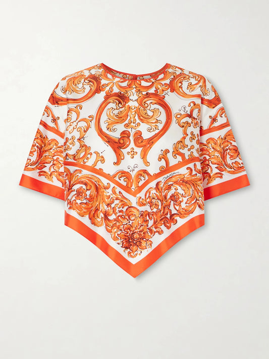 Image of a model wearing Tops. Product name - Printed Silk-twill Blouse in Orange colour by brand - Dolce & Gabbana