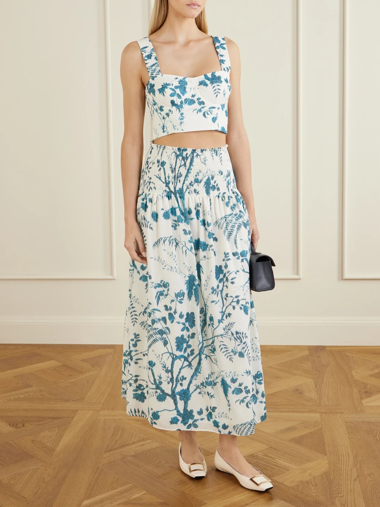 Image of a model wearing Skirts. Product name - Shirred Floral-print Cotton And Linen-blend Midi Skirt in White colour by brand - Erdem