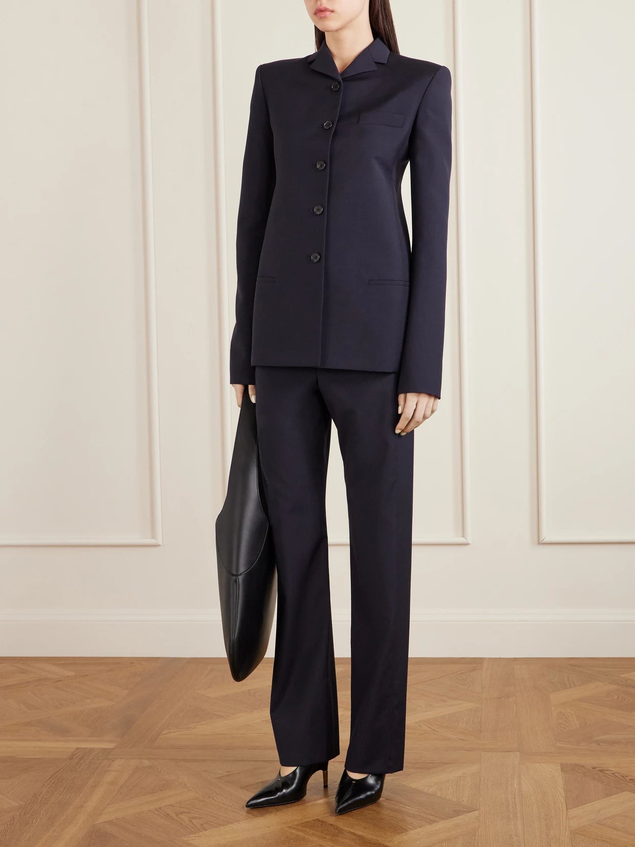 Image of a model wearing Outerwear. Product name - Celton Wool Blazer in Navy colour by brand - KHAITE