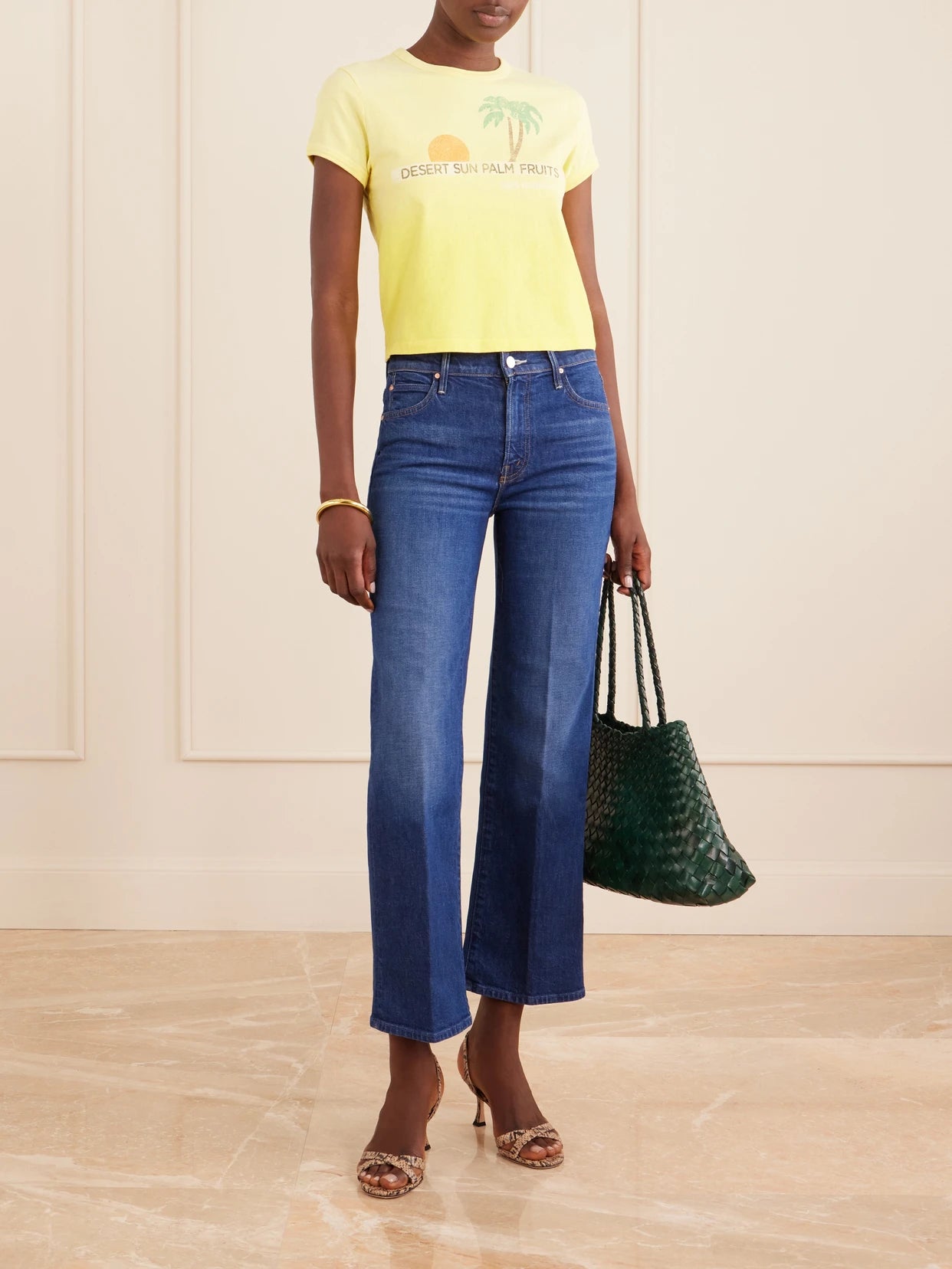 Image of a model wearing Tops. Product name - The Itty Bitty Ringer Printed Cotton-jersey T-shirt in Yellow colour by brand - Mother