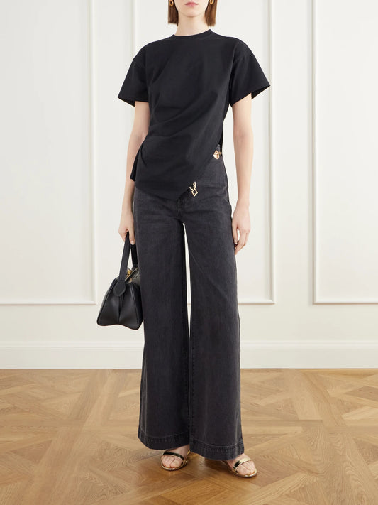 Image of a model wearing Tops. Product name - Cata Asymmetric Pleated Cotton-jersey T-shirt in Black colour by brand - Cult Gaia