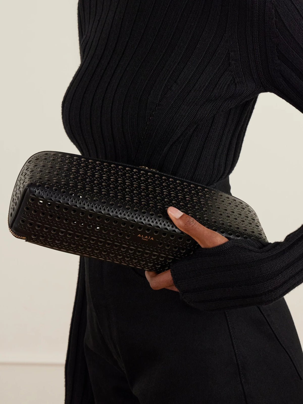 Image of Bags. Product name - Delta Laser-cut Leather Clutch in Black colour by brand - Alaïa