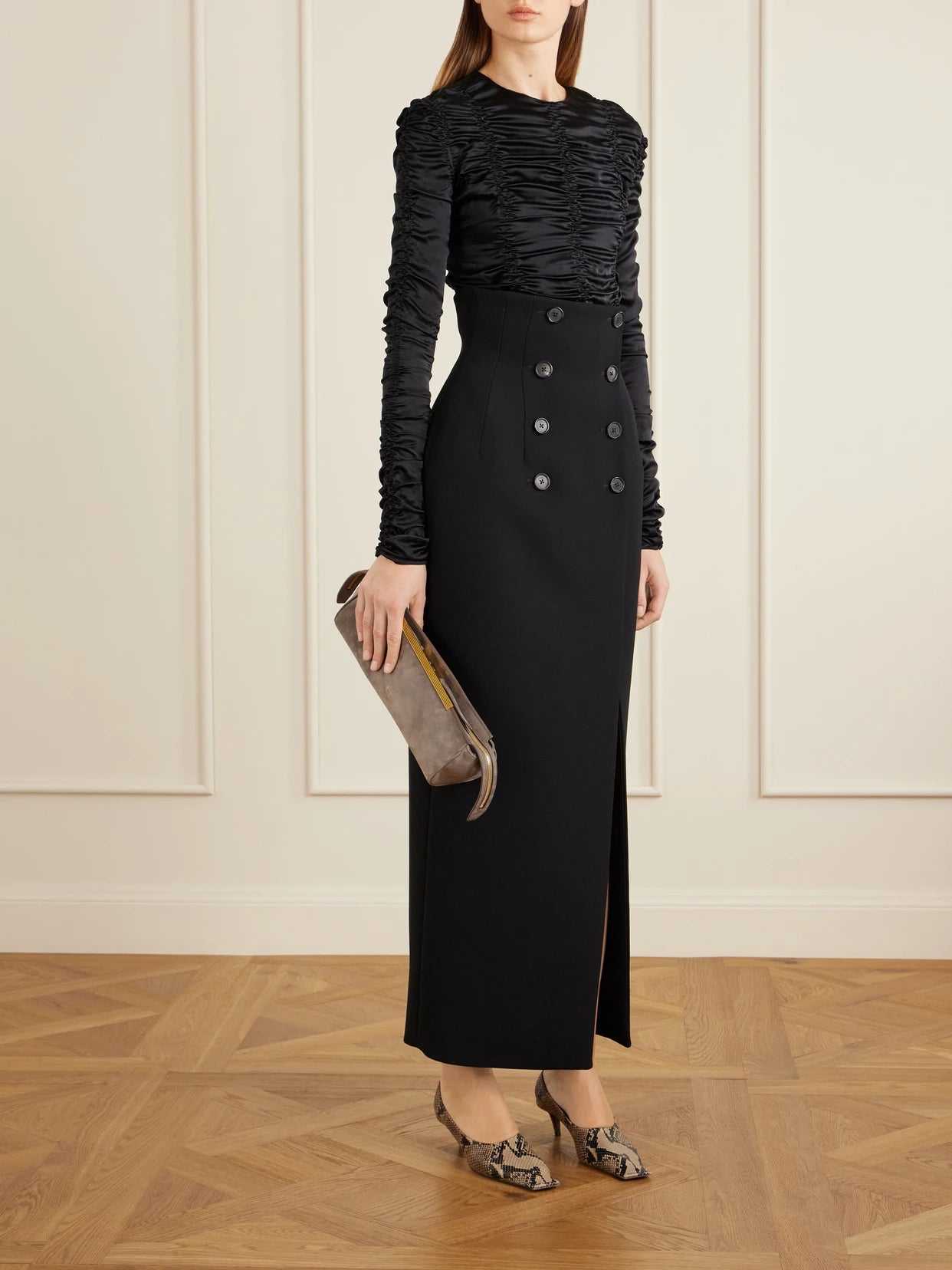 Image of a model wearing Tops. Product name - Rory Ruched Silk-satin Top in Black colour by brand - KHAITE