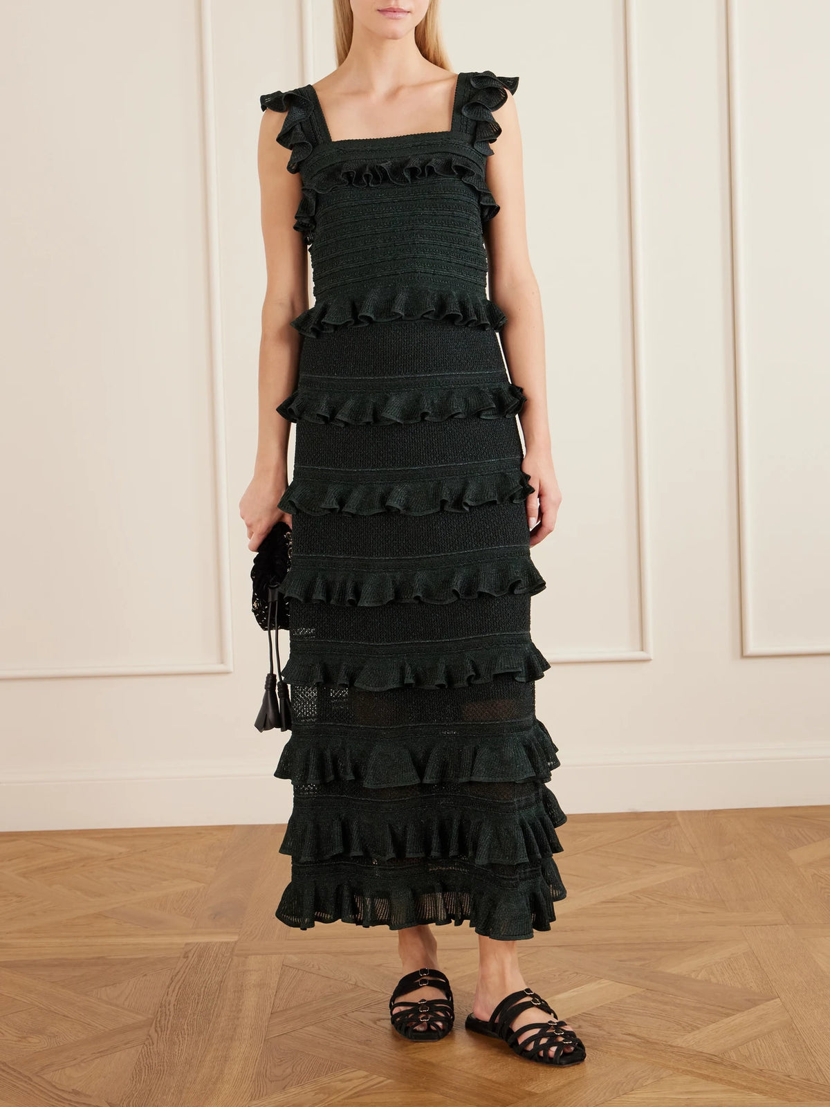 Image of a model wearing Skirts. Product name - Valiant Ruffled Knitted Midi Skirt in Green colour by brand - Zimmermann