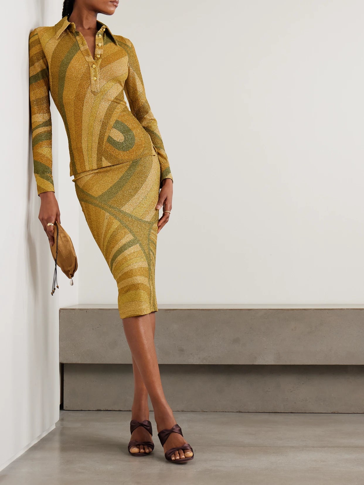 Image of a model wearing Tops. Product name - Printed Metallic Jersey Polo Shirt in Gold colour by brand - PUCCI