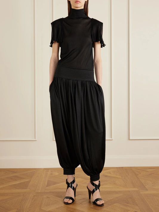 Image of a model wearing Tops. Product name - Cropped Jersey Top in Black colour by brand - Alaïa