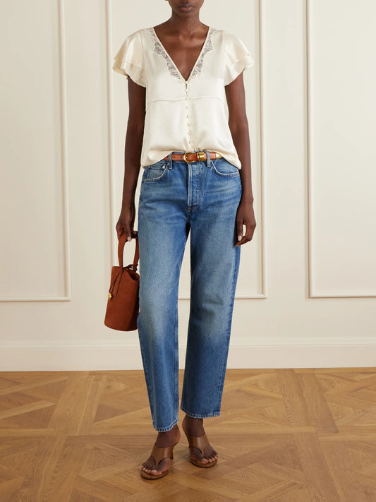 Image of a model wearing Tops. Product name - Lola Flutter Lace-trimmed Satin Blouse in Cream colour by brand - Citizens of Humanity