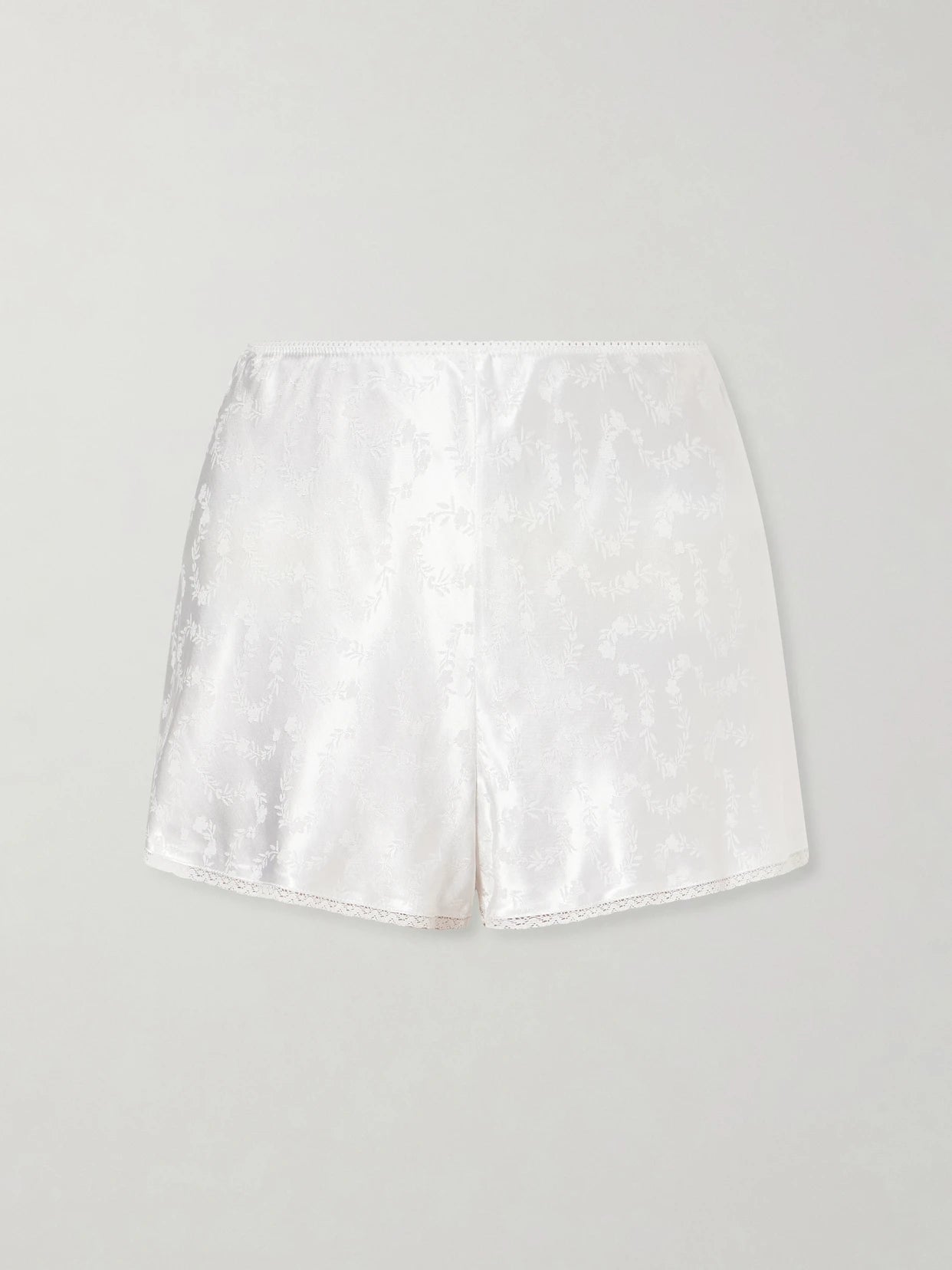 Image of a model wearing Shorts. Product name - Loren Floral Lenzing Ecovero-blend Satin-jacquard Shorts in White colour by brand - DÔEN