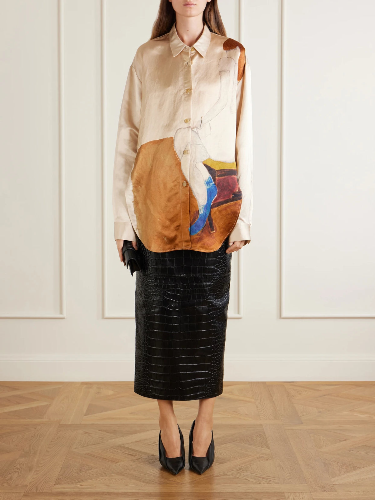 Image of a model wearing Skirts. Product name - Loxley Croc-effect Leather Midi Skirt in Black colour by brand - KHAITE
