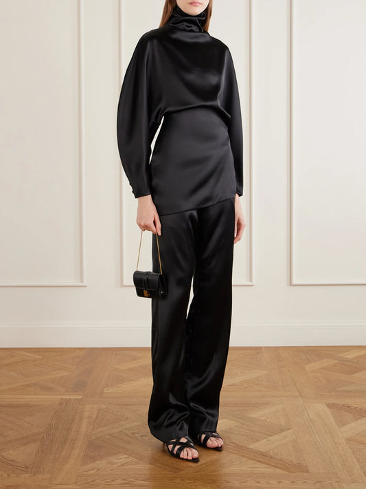 Image of a model wearing Pants. Product name - Hunter Pleated Satin Straight-leg Pants in Black colour by brand - KHAITE