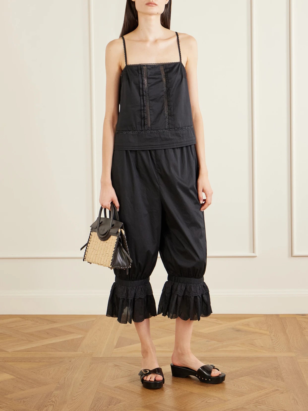 Image of a model wearing Tops. Product name - Corinna Lace-trimmed Cotton Top in Black colour by brand - STAUD