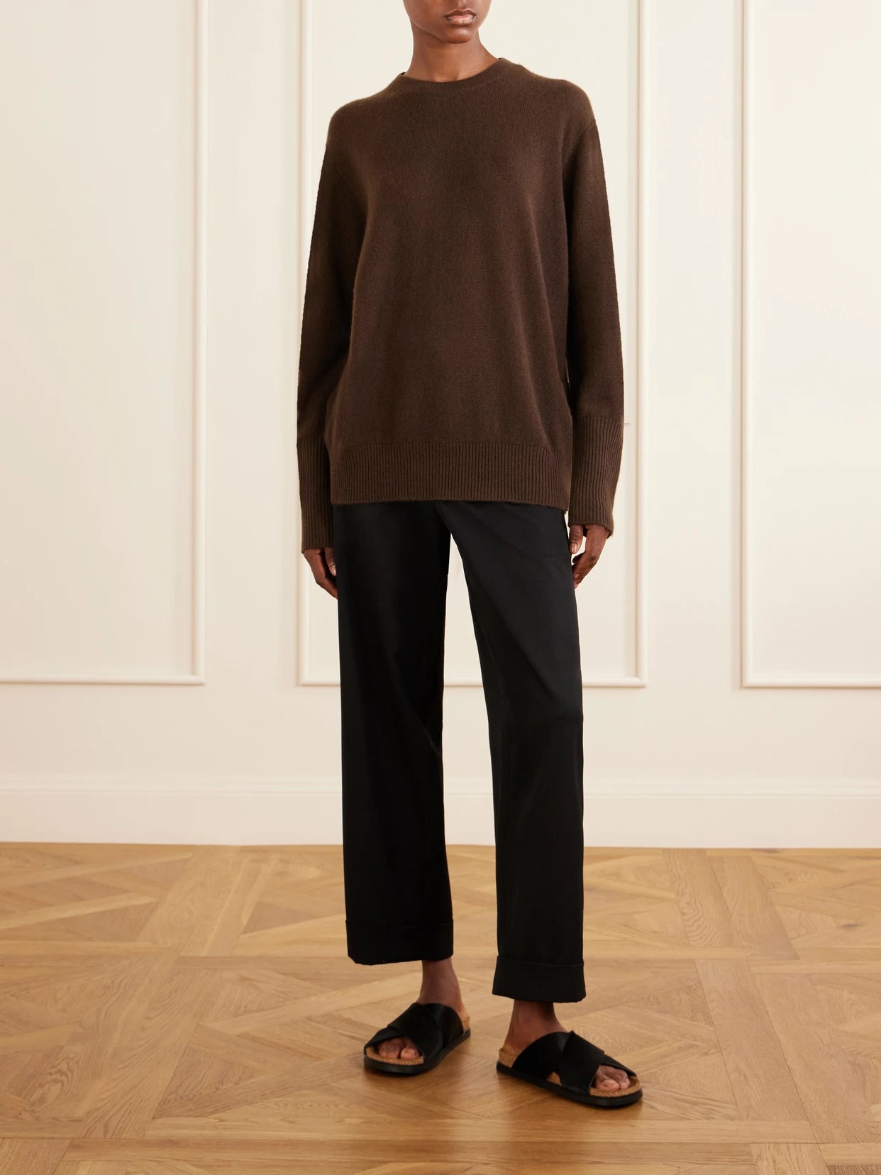 Image of a model wearing Outerwear. Product name - Odelle Cashmere Knit in Dark brown colour by brand - The Row