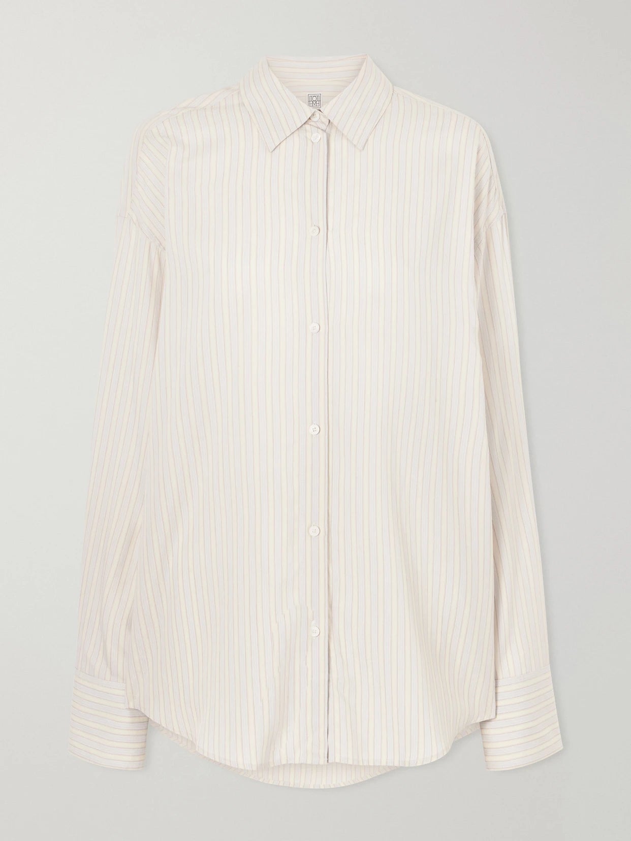 Image of a model wearing Tops. Product name - Striped Woven Shirt in Multi colour by brand - TOTEME
