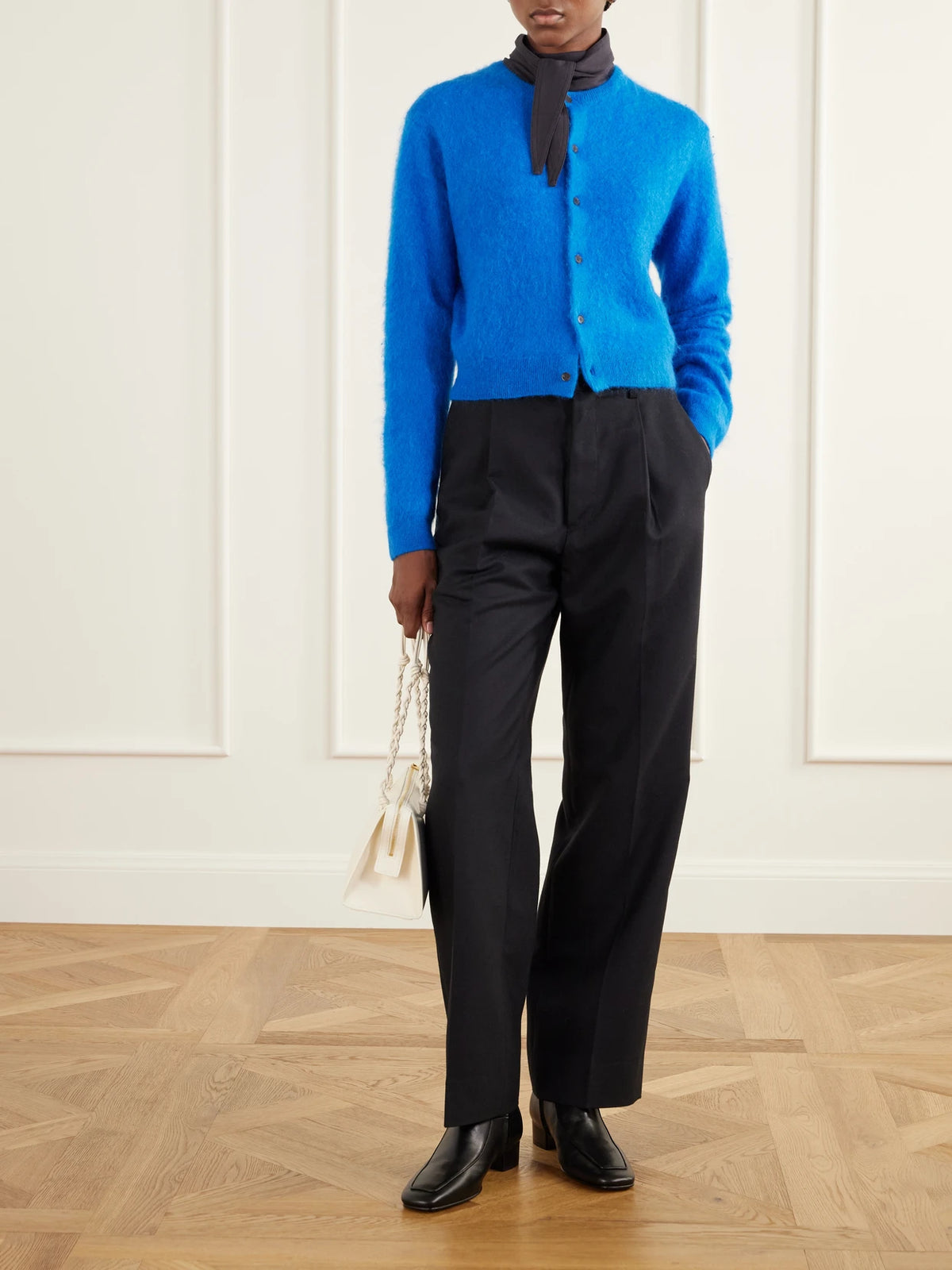 Image of a model wearing Outerwear. Product name - Garment-dyed Alpaca Cardigan in Royal blue colour by brand - Auralee