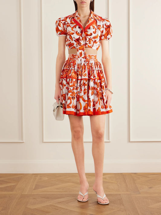 Image of a model wearing Skirts. Product name - Printed Cotton-poplin Mini Skirt in Orange colour by brand - Dolce & Gabbana