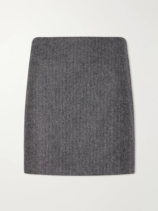 Image of a model wearing Skirts. Product name - Coci Herringbone Wool-blend Mini Skirt in Gray colour by brand - BLAZÉ Milano