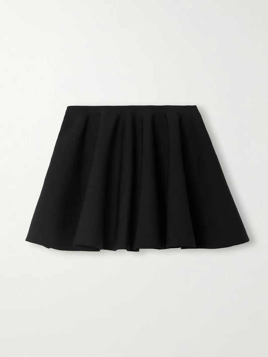 Image of a model wearing Skirts. Product name - Pleated Stretch-knit Mini Skirt in Black colour by brand - Alaïa