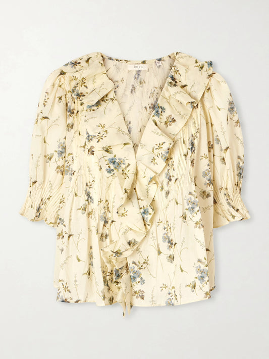 Image of a model wearing Tops. Product name - Henri Ruffled Pintucked Organic Cotton-voile Top in Pastel yellow colour by brand - DÔEN