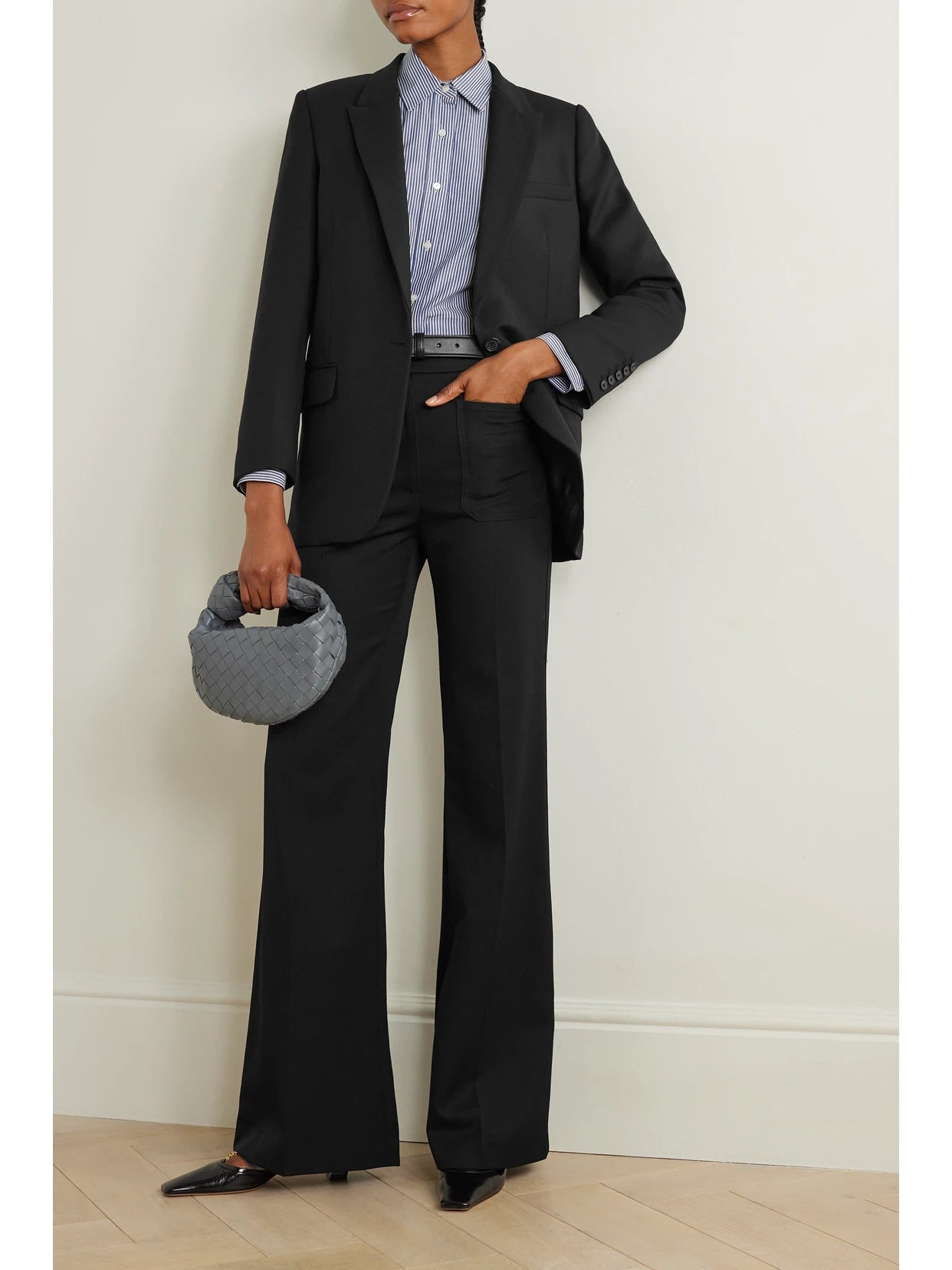 Image of a model wearing Outerwear. Product name - Diane Stretch-wool Twill Blazer in Black colour by brand - Nili Lotan