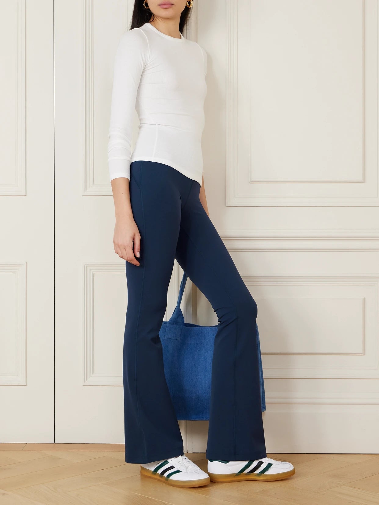Image of a model wearing Pants. Product name - Groove High-rise Flared Pant With Pockets 32.5" in Navy colour by brand - lululemon