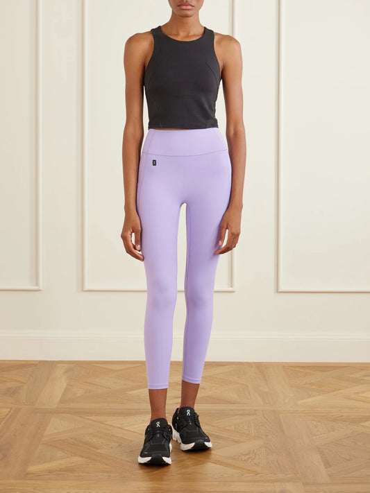 Image of a model wearing Pants. Product name - Apparel Studio Sensetec Leggings in Lilac colour by brand - ON