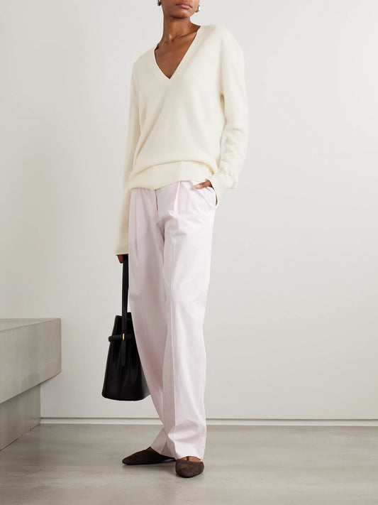 Image of a model wearing Outerwear. Product name - Garderob Cashmere Sweater in Ecru colour by brand - TOTEME