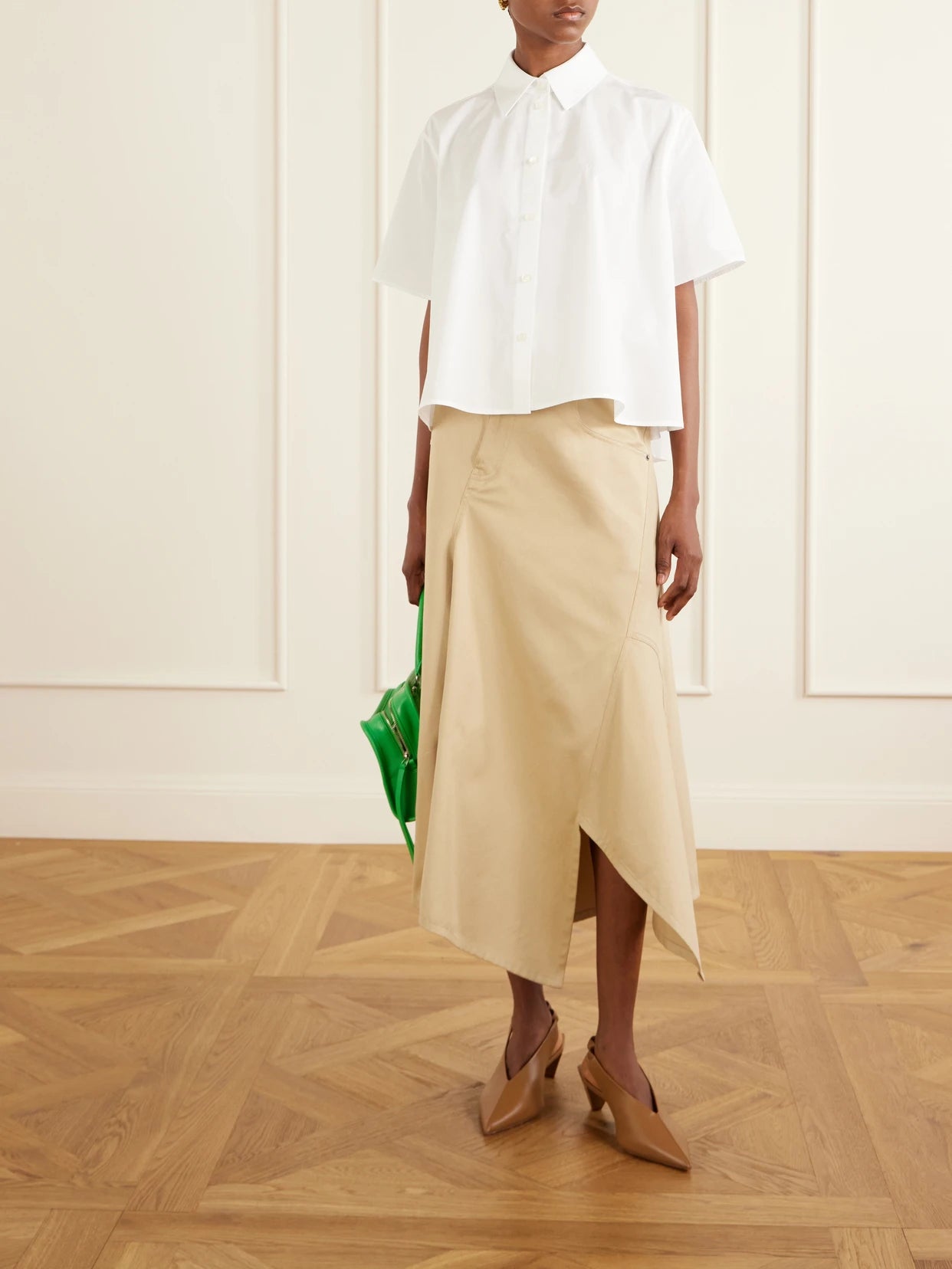 Image of a model wearing Tops. Product name - Logo-embroidered Cotton-poplin Shirt in White colour by brand - LOEWE