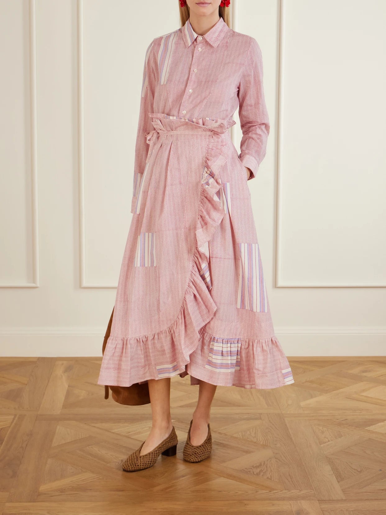 Image of a model wearing Skirts. Product name - Tasha Ruffled Striped Cotton-voile Wrap Midi Skirt in Pink colour by brand - Thierry Colson