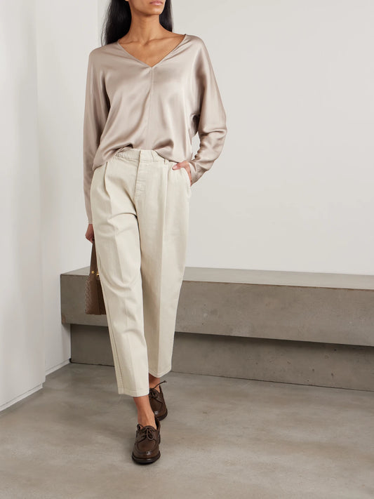 Image of a model wearing Pants. Product name - Cropped Pleated Stretch-cotton Twill Tapered Pants in White colour by brand - Brunello Cucinelli